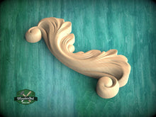 Load image into Gallery viewer, A wooden carving of a scroll-like design is displayed against a green background.