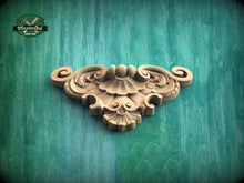 Load image into Gallery viewer, A decorative wooden carving or mold is displayed against a green textured background.