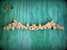 Load image into Gallery viewer, a wood carving of flowers and leaves on a green background