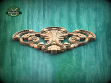 Load image into Gallery viewer, a wood carving of an ornate design on a green background