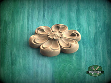 Load image into Gallery viewer, A wooden flower-shaped object is displayed against a green background.