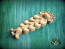 Load image into Gallery viewer, A wooden flower-shaped object with a curved petal design is shown against a green background.