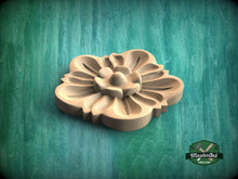 Load image into Gallery viewer, A wooden flower-shaped object is displayed against a green background.