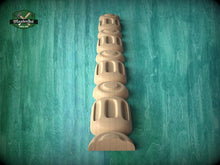 Load image into Gallery viewer, A wooden carving of a tall, cylindrical object with a series of smaller cylindrical shapes stacked vertically, set against a green textured background.