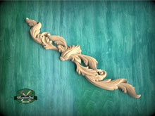 Load image into Gallery viewer, a wood carving of a flower on a green background