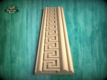 Load image into Gallery viewer, a wooden carving with a repeating geometric pattern, displayed against a green background.