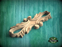 Load image into Gallery viewer, A wooden carving with intricate, organic shapes sits on a green textured surface.