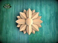Load image into Gallery viewer, A wooden flower-shaped object is centered against a green background.