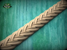 Load image into Gallery viewer, A close-up view of a braided wooden object, possibly a piece of furniture or a decorative item, set against a green wooden background.