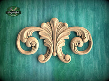Load image into Gallery viewer, a decorative wooden carving on a green background.