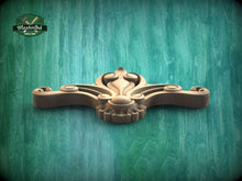 Load image into Gallery viewer, A wooden carving with an intricate design sits on a green wooden surface.
