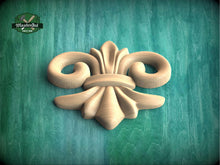 Load image into Gallery viewer, a wood carving of a flower on a green background