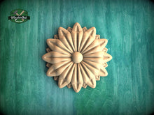 Load image into Gallery viewer, A wooden flower-shaped object is displayed against a green background.