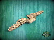 Load image into Gallery viewer, a wooden carving of a dragon on a green background