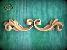 Load image into Gallery viewer, a wood carving of two wavy scrolls on a green background