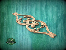 Load image into Gallery viewer, A decorative wooden carving with intricate scrollwork is displayed against a green textured background.