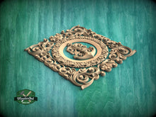 Load image into Gallery viewer, a decorative wooden carving of a musical instrument, surrounded by intricate floral patterns, set against a teal-colored background.