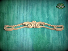 Load image into Gallery viewer, A decorative wooden carving with intricate scrollwork is displayed against a green textured background.