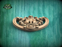 Load image into Gallery viewer, A wooden decorative piece with an intricate floral design is displayed against a green background.