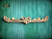 Load image into Gallery viewer, a wood carving of a flower on a green background