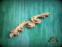 Load image into Gallery viewer, a wood carving of a flower on a green background