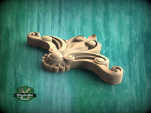 Load image into Gallery viewer, A wooden carving of an ornate, floral-shaped object is displayed against a teal-colored background.