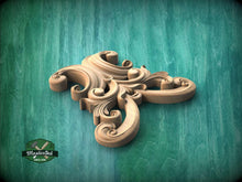 Load image into Gallery viewer, A carved wooden ornament in the shape of an octopus, with intricate swirls and curves, is displayed against a green background.