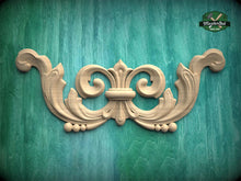 Load image into Gallery viewer, A decorative wooden carving in the shape of a scroll or scrollwork is displayed against a teal-colored background.