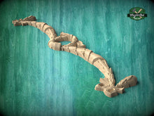 Load image into Gallery viewer, A wooden dragon sculpture is displayed against a teal background.