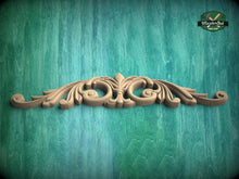 Load image into Gallery viewer, A decorative wooden carving with an intricate design is displayed against a textured green background.