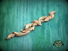 Load image into Gallery viewer, a wood carving of a flower on a green background