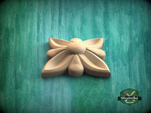 Load image into Gallery viewer, A wooden flower-shaped object is displayed against a green background.