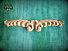 Load image into Gallery viewer, A decorative wooden carving with a floral pattern is displayed against a teal-colored background.
