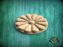 Load image into Gallery viewer, A wooden flower-shaped object is centered against a green background.