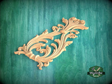 Load image into Gallery viewer, a decorative wooden carving on a green background.