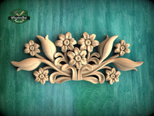 Load image into Gallery viewer, A decorative wooden carving of flowers and leaves on a green background.