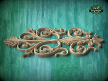 Load image into Gallery viewer, a decorative wooden carving with intricate scrollwork and floral elements, set against a textured green background.
