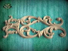 Load image into Gallery viewer, a decorative wooden carving with intricate scrollwork and floral patterns, set against a green textured background.
