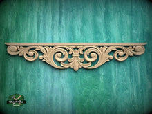Load image into Gallery viewer, a decorative wooden carving on a green wooden surface.

