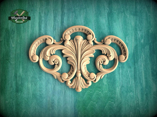 a wood carving of an ornate design on a green background