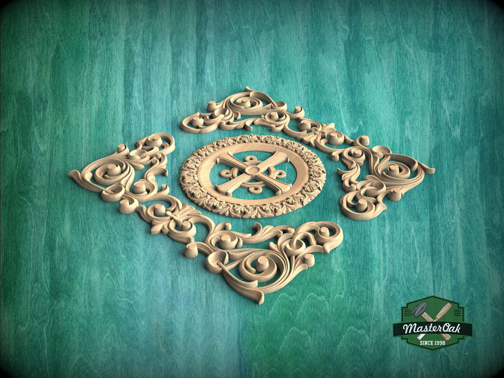 a decorative wooden carving with intricate scrollwork and a central motif, set against a green background.