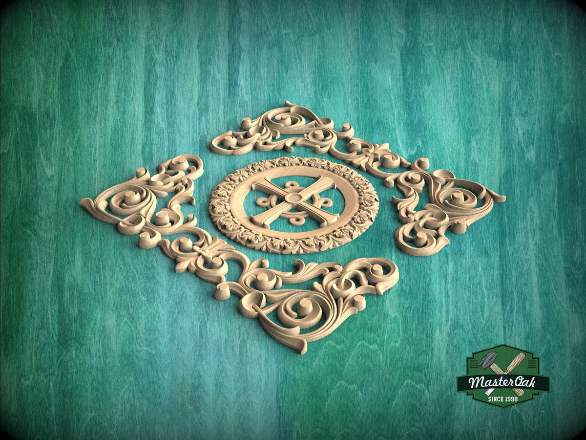 a decorative wooden carving with intricate scrollwork and a central motif, set against a green background.