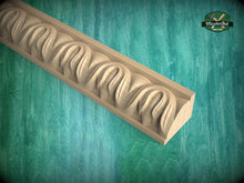 Load image into Gallery viewer, A wooden carving with a curved, organic design is displayed against a green background.
