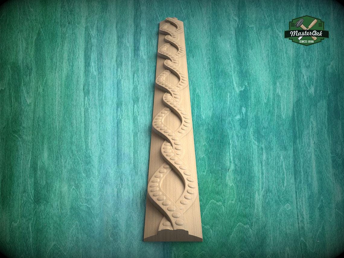 A wooden carving of a spiral pattern is displayed against a green background.
