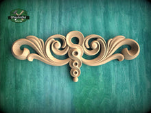 Load image into Gallery viewer, a decorative wooden carving on a green background.
