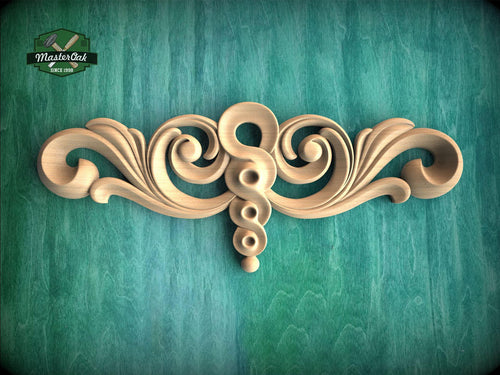 a decorative wooden carving on a green background.