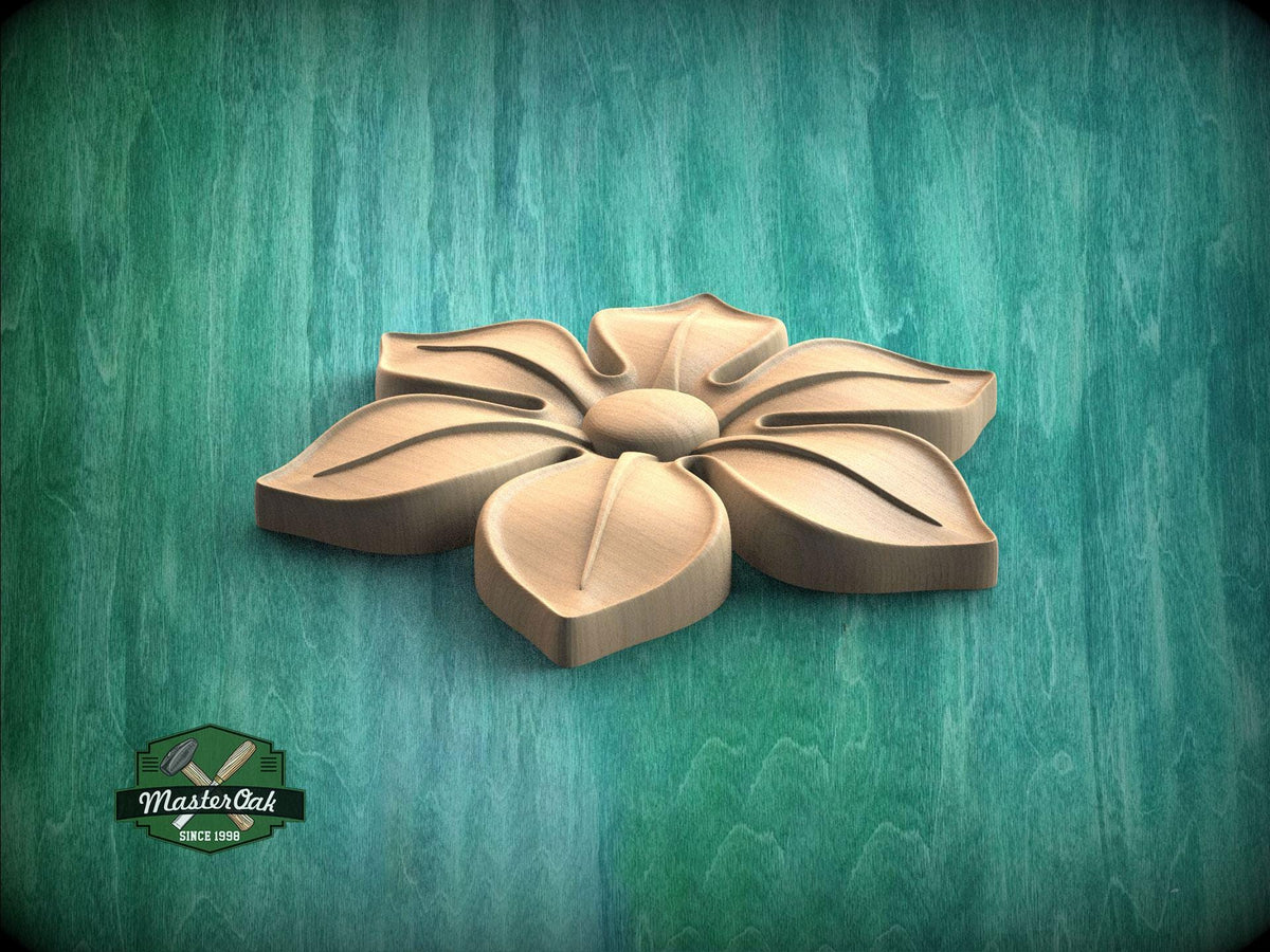 A wooden flower carving is displayed against a green background.