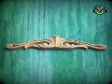 Load image into Gallery viewer, A decorative wooden mold or carving is displayed against a green textured background.
