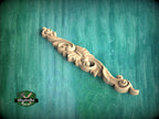 a carved wooden handle on a green background