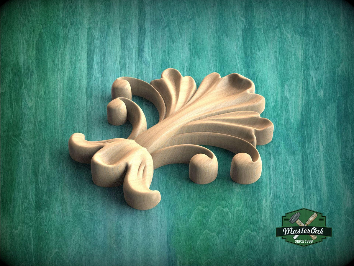 A wooden carving of a stylized flower or leaf design is displayed against a green background.